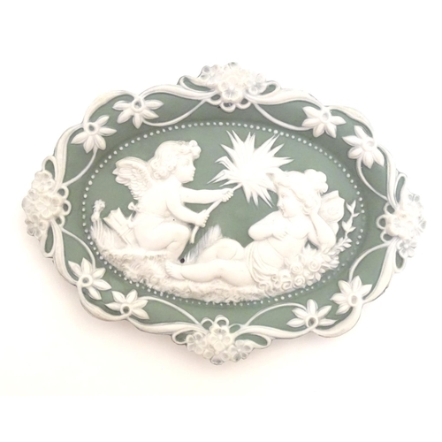 124 - A matched pair of Continental oval wall plaques with jasperware style decoration with putti, flowers... 