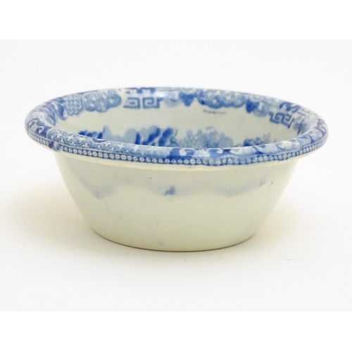 129 - A 19thC blue and white small strainer, decorated with an Oriental landscape scene with pagodas etc. ... 