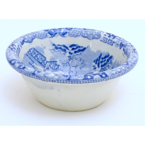 129 - A 19thC blue and white small strainer, decorated with an Oriental landscape scene with pagodas etc. ... 