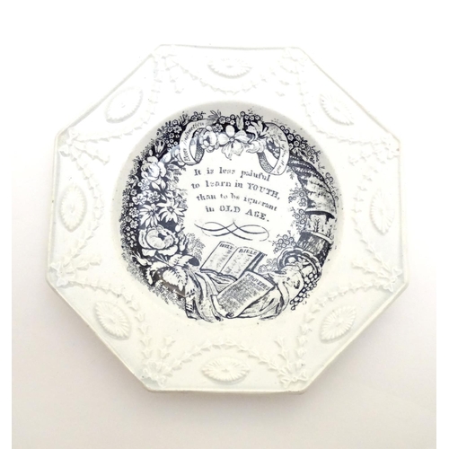 135 - A 19thC monochrome nursery plate of octagonal form, decorated with a floral and foliate wreath, a ho... 