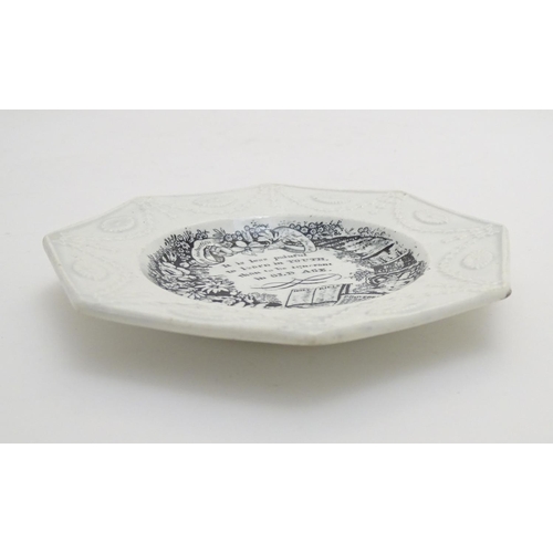 135 - A 19thC monochrome nursery plate of octagonal form, decorated with a floral and foliate wreath, a ho... 