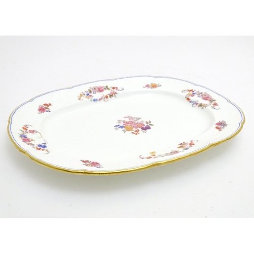 137 - A 19thC Mintons oval serving plate with a lobed rim decorated with floral motifs and gilt highlights... 