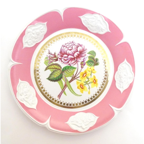 138 - A Continental cabinet plate with central peony flower detail and relief border. Approx. 8 3/4