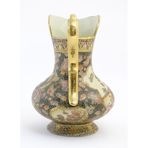 14 - An Oriental jug / ewer with a bulbous body decorated with panels depicting ladies in a garden terrac... 