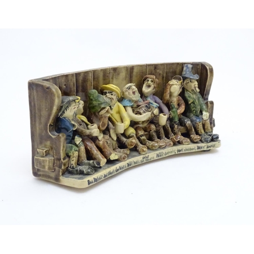 140A - A Will Young ceramic group depicting the characters from Widecombe Fair seated on a tavern settle. W... 