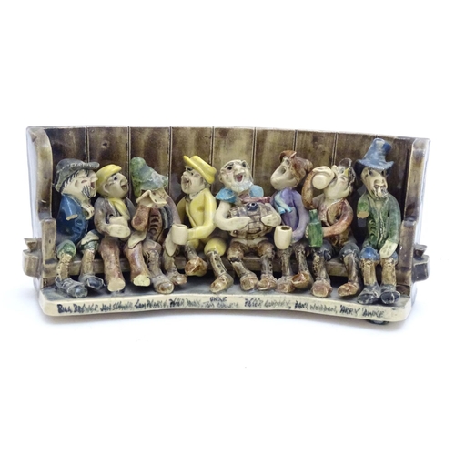 140A - A Will Young ceramic group depicting the characters from Widecombe Fair seated on a tavern settle. W... 