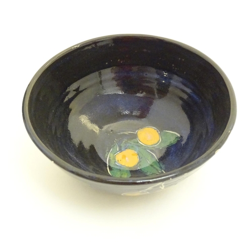 150 - Two items of Irish studio pottery comprising a bowl decorated with stylised lemons and foliage, and ... 