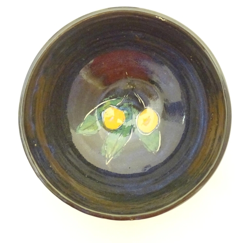 150 - Two items of Irish studio pottery comprising a bowl decorated with stylised lemons and foliage, and ... 