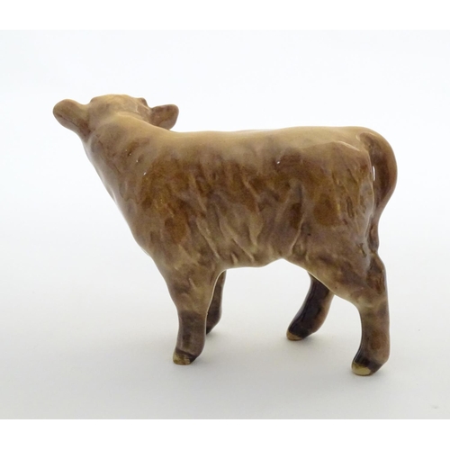 157 - A Beswick Highland calf, model no. 1827D, designed by Arthur Gredington. Marked under. Approx. 3