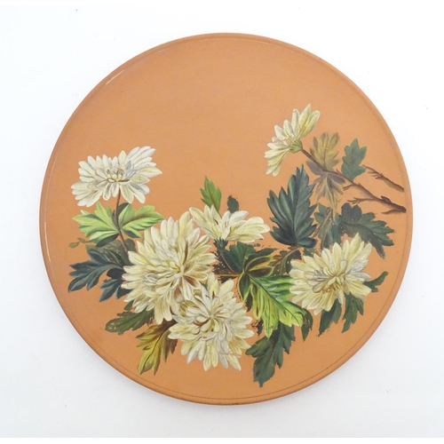 166 - A Longpark Torquay terracotta charger with chrysanthemum flower decoration. Impressed mark and indis... 