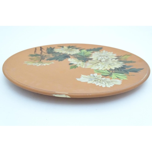 166 - A Longpark Torquay terracotta charger with chrysanthemum flower decoration. Impressed mark and indis... 