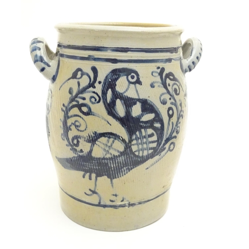 181 - A stoneware crock pot of ovoid form with twin handles and hand painted bird and scrolling foliage de... 