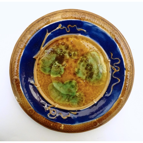 196 - A Spanish Puigdemont majolica slipware plate / charger with fish and coral decoration. Signed under.... 