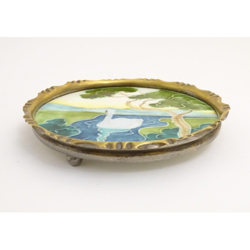 62 - A German Art Nouveau card tray / dish with tube lined enamelled detail depicting a river landscape w... 