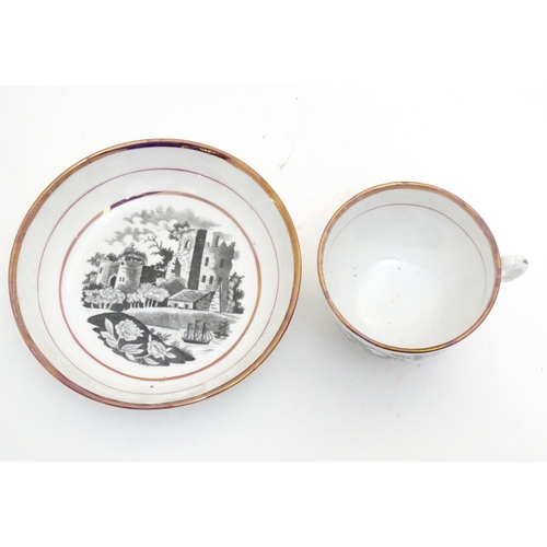 66 - A 19thC tea cup and saucer with monochrome transfer decoration depicting a river landscape with a sh... 