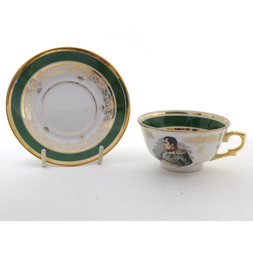 69 - A French tea cup and saucer depicting Emperor Napoleon with green and gilt highlights. Porcelaine de... 