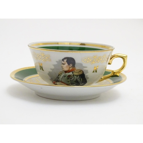 69 - A French tea cup and saucer depicting Emperor Napoleon with green and gilt highlights. Porcelaine de... 