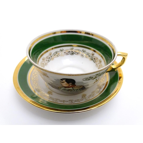 69 - A French tea cup and saucer depicting Emperor Napoleon with green and gilt highlights. Porcelaine de... 