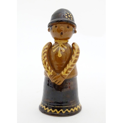 75 - A terracotta figure with slipware decoration modelled as a woman singing. Incised marks under. Appro... 