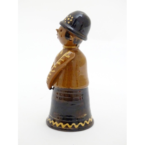 75 - A terracotta figure with slipware decoration modelled as a woman singing. Incised marks under. Appro... 