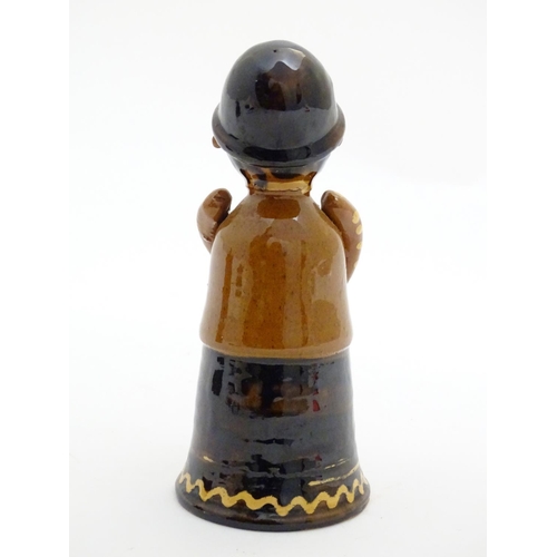 75 - A terracotta figure with slipware decoration modelled as a woman singing. Incised marks under. Appro... 