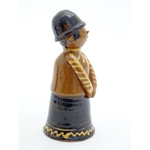 75 - A terracotta figure with slipware decoration modelled as a woman singing. Incised marks under. Appro... 