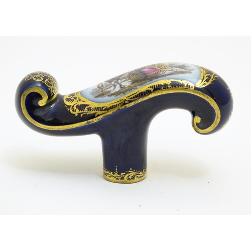 77 - A Continental ceramic cane handle with a cobalt blue ground and hand painted winter scene depicting ... 