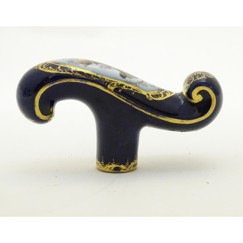 77 - A Continental ceramic cane handle with a cobalt blue ground and hand painted winter scene depicting ... 