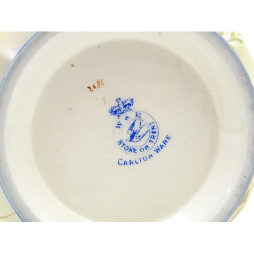 78 - A Wiltshaw & Robinson Carlton Ware jug with floral decoration, with silver plate mounts and handle. ... 