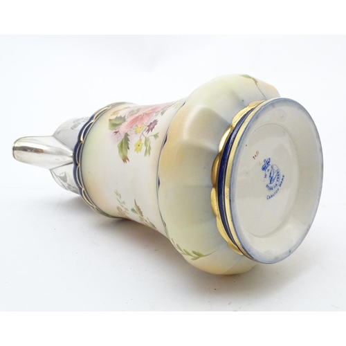 78 - A Wiltshaw & Robinson Carlton Ware jug with floral decoration, with silver plate mounts and handle. ... 