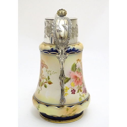 78 - A Wiltshaw & Robinson Carlton Ware jug with floral decoration, with silver plate mounts and handle. ... 