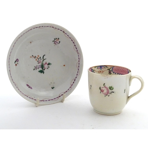 79 - A New Hall tea cup with hand painted floral decoration. Together with a saucer with hand painted flo... 