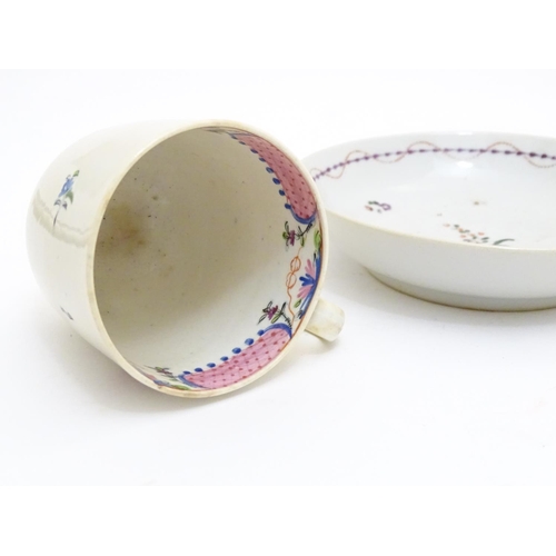 79 - A New Hall tea cup with hand painted floral decoration. Together with a saucer with hand painted flo... 