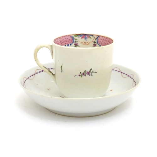 79 - A New Hall tea cup with hand painted floral decoration. Together with a saucer with hand painted flo... 