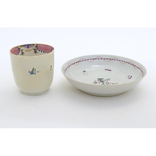 79 - A New Hall tea cup with hand painted floral decoration. Together with a saucer with hand painted flo... 