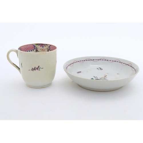 79 - A New Hall tea cup with hand painted floral decoration. Together with a saucer with hand painted flo... 