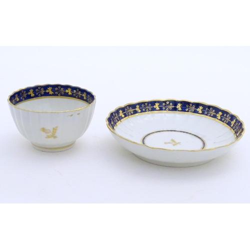 80 - A Fight & Barr Worcester fluted tea bowl and saucer with gilt thistle motifs and a blue and gilt bor... 