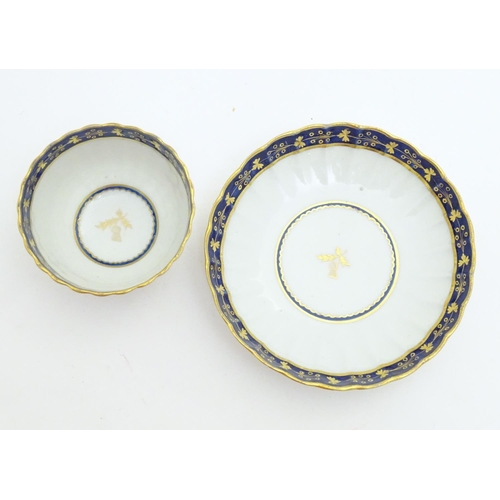 80 - A Fight & Barr Worcester fluted tea bowl and saucer with gilt thistle motifs and a blue and gilt bor... 