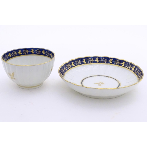 80 - A Fight & Barr Worcester fluted tea bowl and saucer with gilt thistle motifs and a blue and gilt bor... 