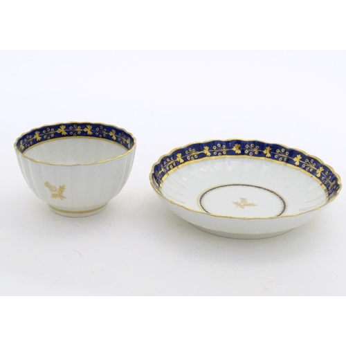 80 - A Fight & Barr Worcester fluted tea bowl and saucer with gilt thistle motifs and a blue and gilt bor... 