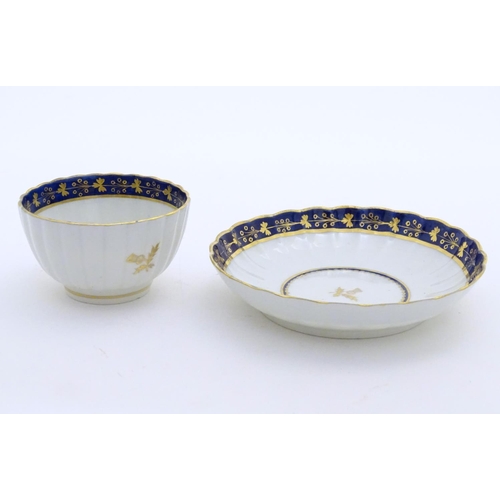 80 - A Fight & Barr Worcester fluted tea bowl and saucer with gilt thistle motifs and a blue and gilt bor... 