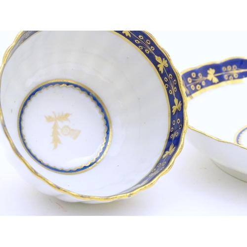 80 - A Fight & Barr Worcester fluted tea bowl and saucer with gilt thistle motifs and a blue and gilt bor... 