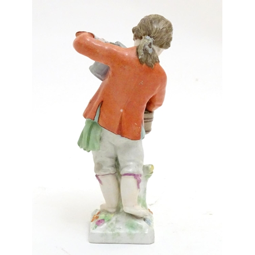 86 - A Continental porcelain figure modelled as a boy with a watering can tending to a pot of flowers. Ma... 