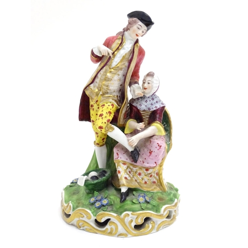 88 - A large Derby porcelain figural group depicting a young couple on a naturalistic base with flowers. ... 