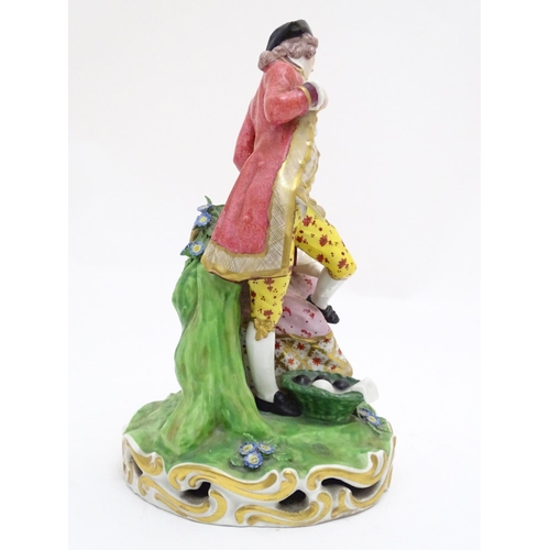 88 - A large Derby porcelain figural group depicting a young couple on a naturalistic base with flowers. ... 