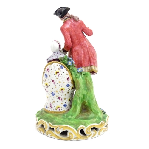 88 - A large Derby porcelain figural group depicting a young couple on a naturalistic base with flowers. ... 