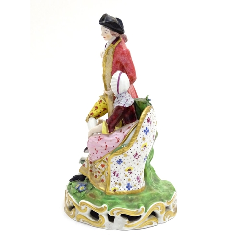 88 - A large Derby porcelain figural group depicting a young couple on a naturalistic base with flowers. ... 