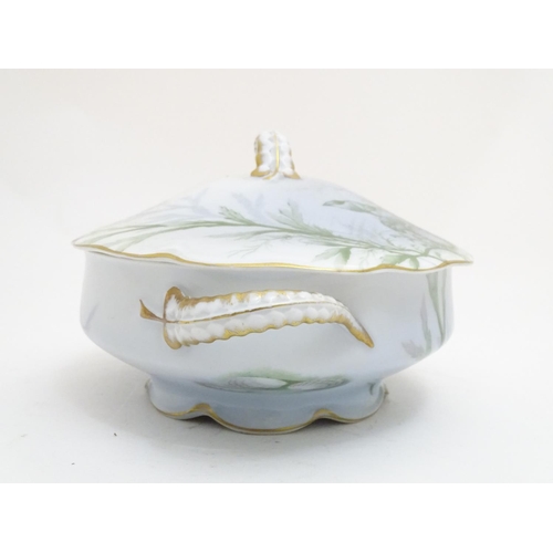 92 - A late 19thC Rosenthal oval scallop shaped tureen with a lobed gilt edged rim, decorated with underw... 