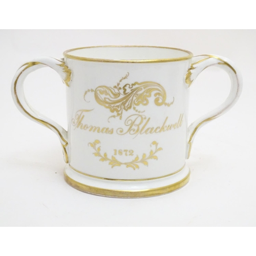 93 - A 19thC loving cup with hand painted floral display to one side and gilt inscription 'Thomas Blackwe... 