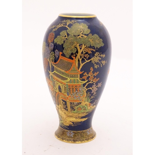 99 - A Wiltshaw and Robinson Carlton Ware baluster vase decorated with a landscape scene with pagodas, br... 